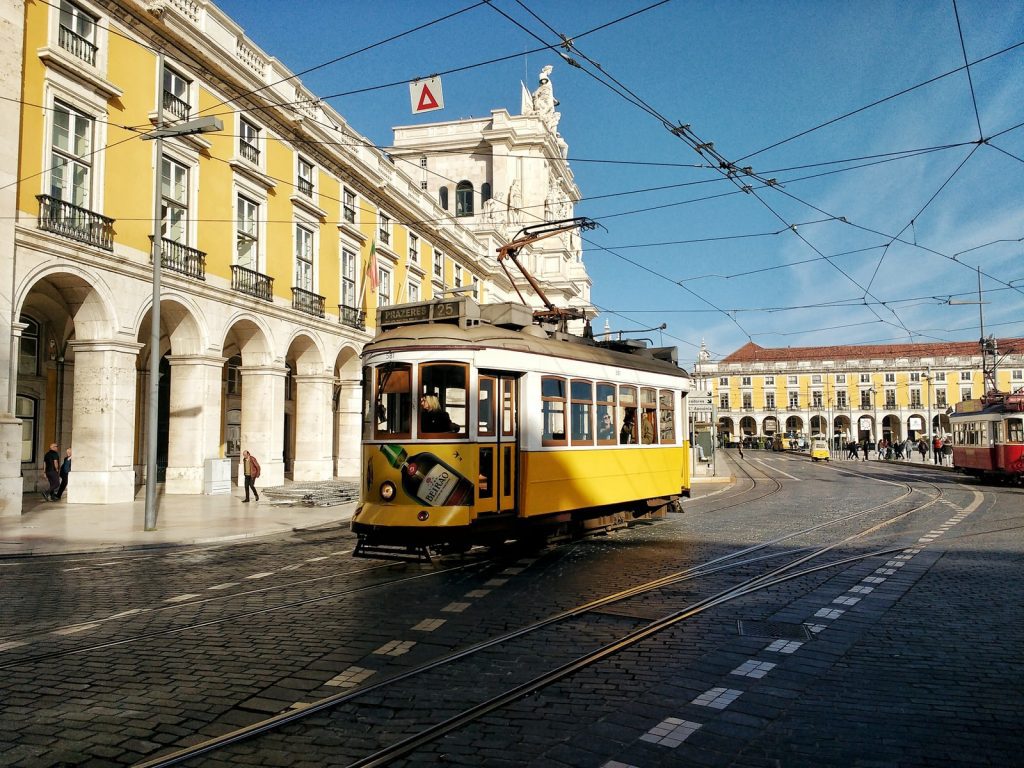 Yellow vintage tram on the street in Lisbon, Portugal.