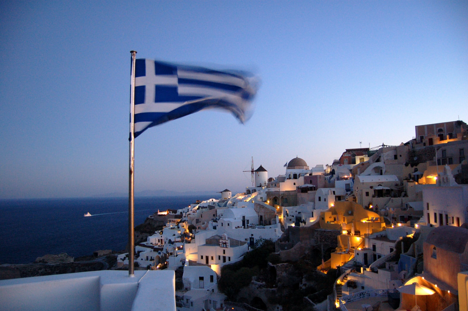 Flag of Greece waving at pole at Santorino, Greece